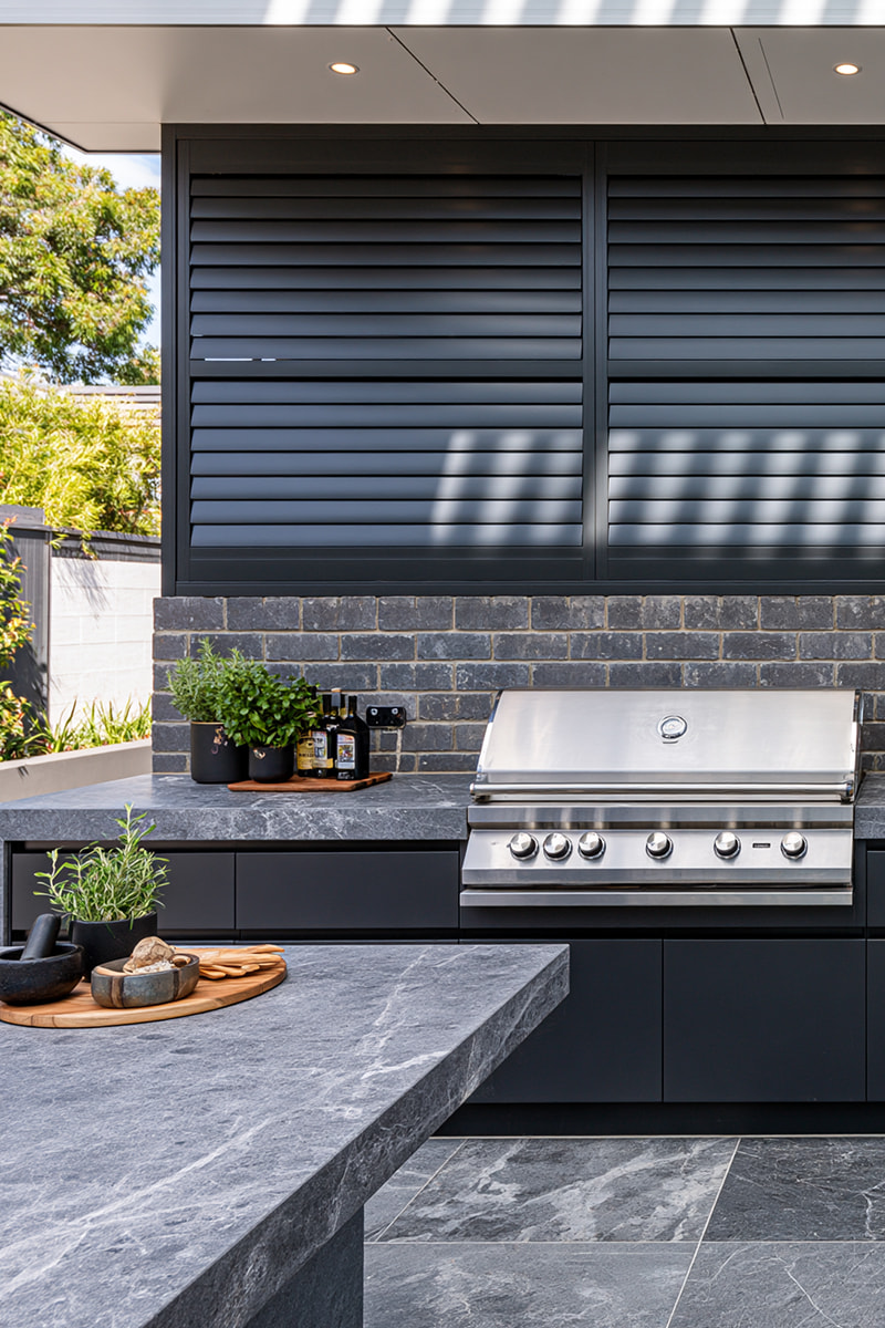 Black aluminium outdoor shutters on an alfresco kitchen