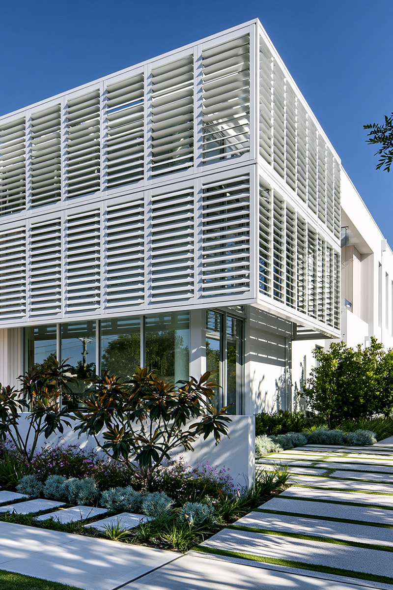 White aluminium shutters on an upper level facade