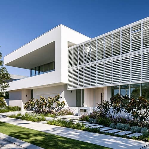 White fixed outdoor shutters installed on a patio